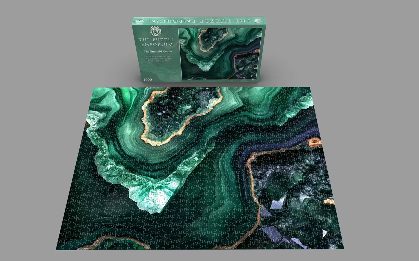 Jigsaw puzzle with green and black marble design and packaging on a gray background