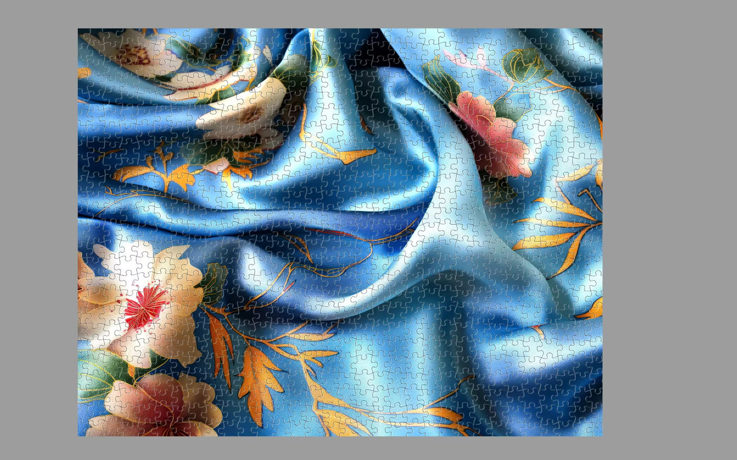 Jigsaw puzzle with a blue fabric and floral design on a gray background