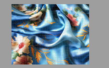 Jigsaw puzzle with a blue fabric and floral design on a gray background