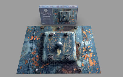 Rust-themed puzzle with packaging labeled 'The Puzzle Emporium' on a gray background