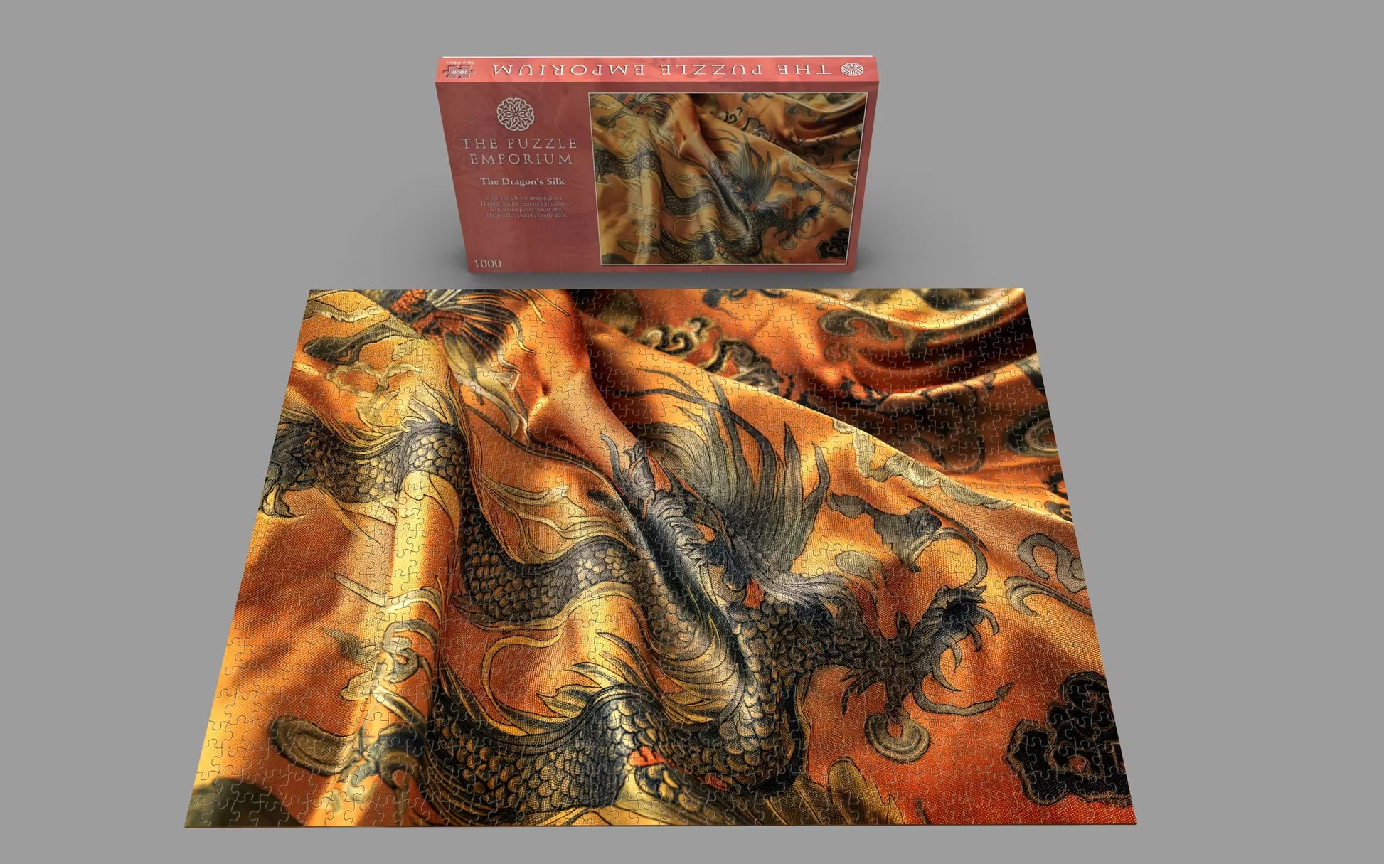 Dragon-patterned fabric with a matching puzzle box on a gray background