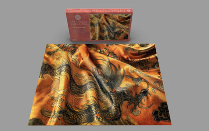 Dragon-patterned fabric with a matching puzzle box on a gray background