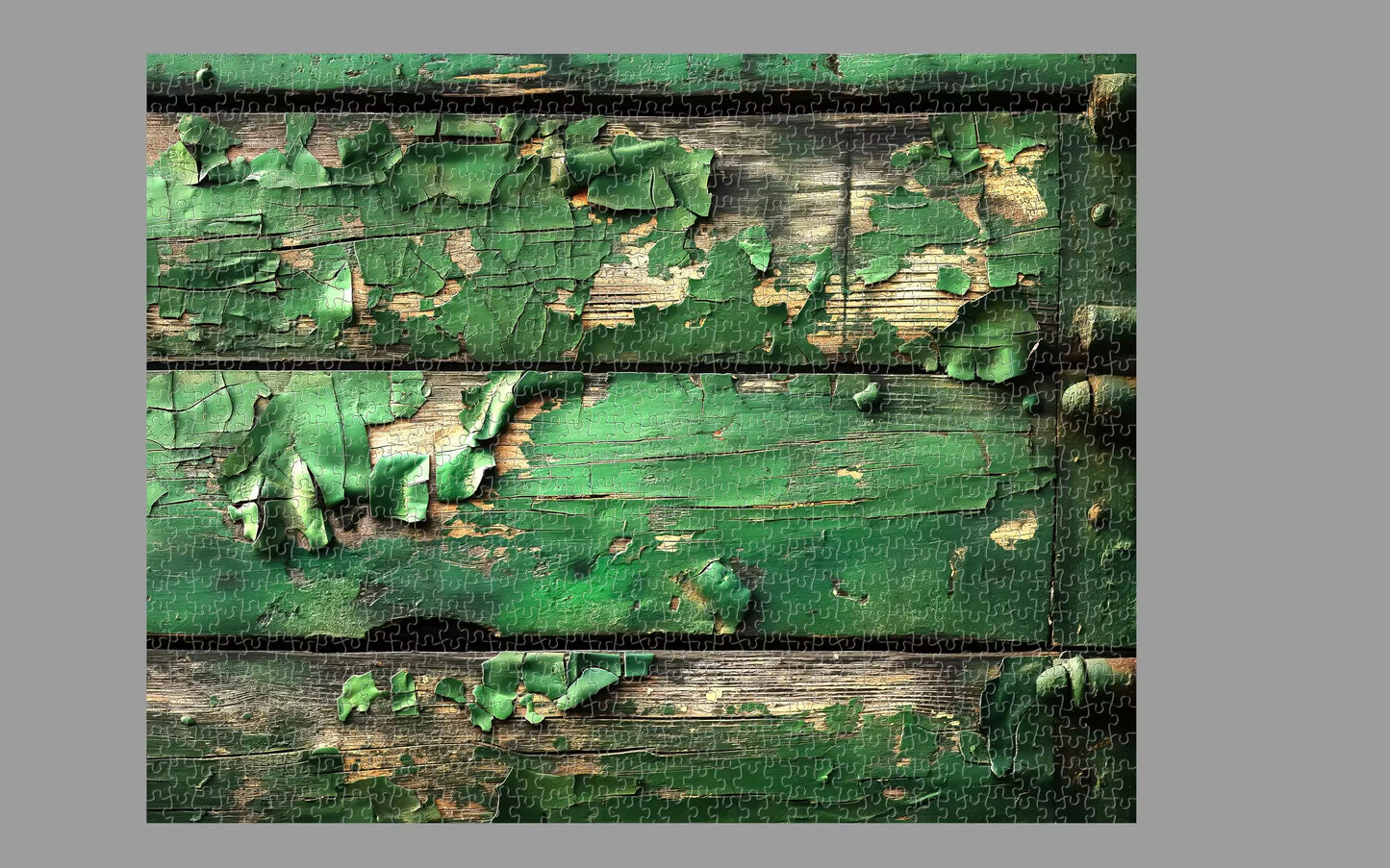 Vintage wooden panel with peeling green paint on a gray background