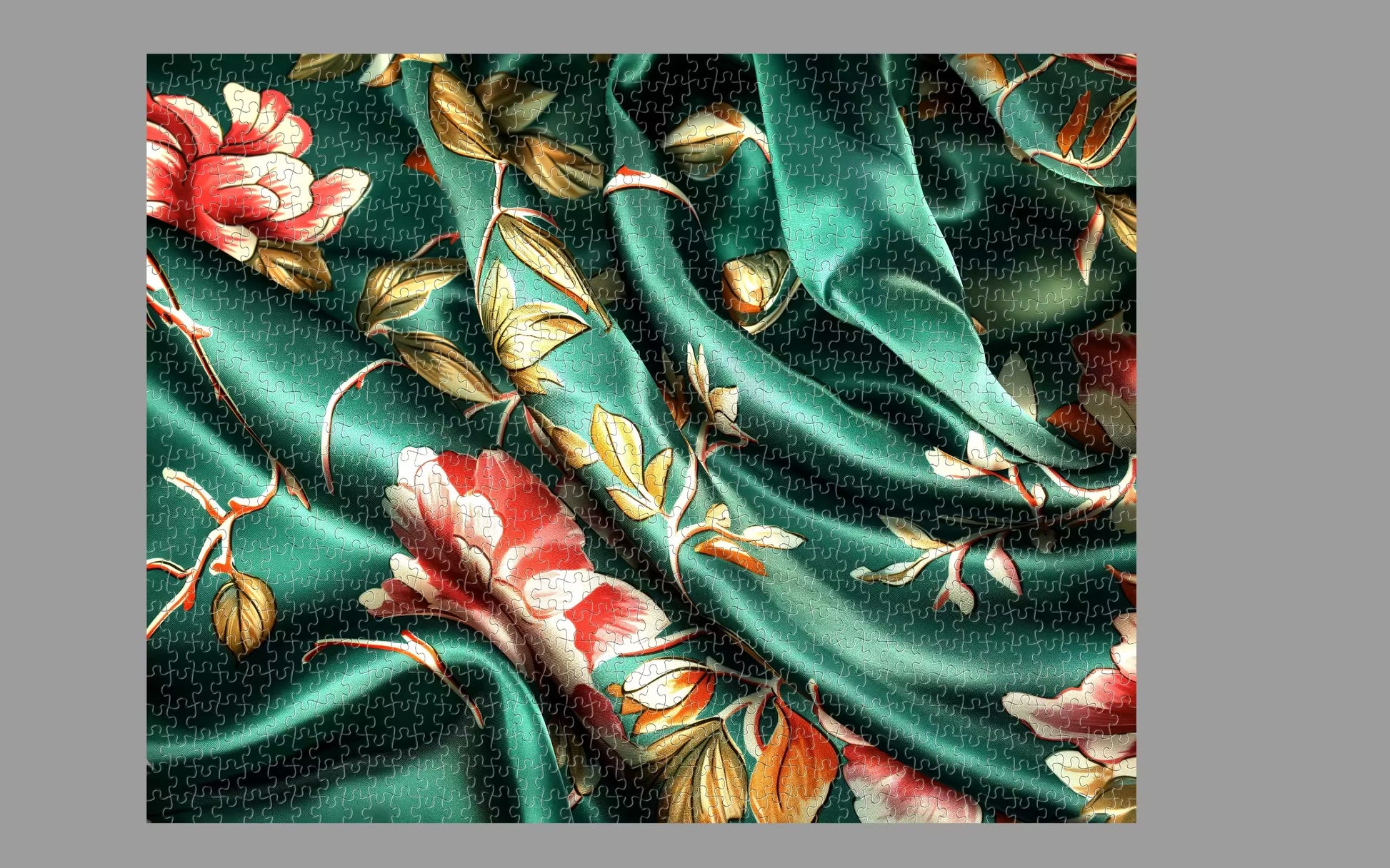 Green fabric with floral patterns on a gray background