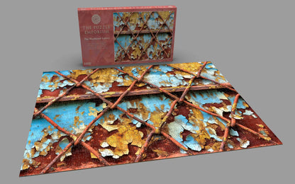 Jigsaw puzzle with decorative design and packaging on a gray background