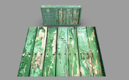 Green puzzle box with peeling paint effect on a gray background