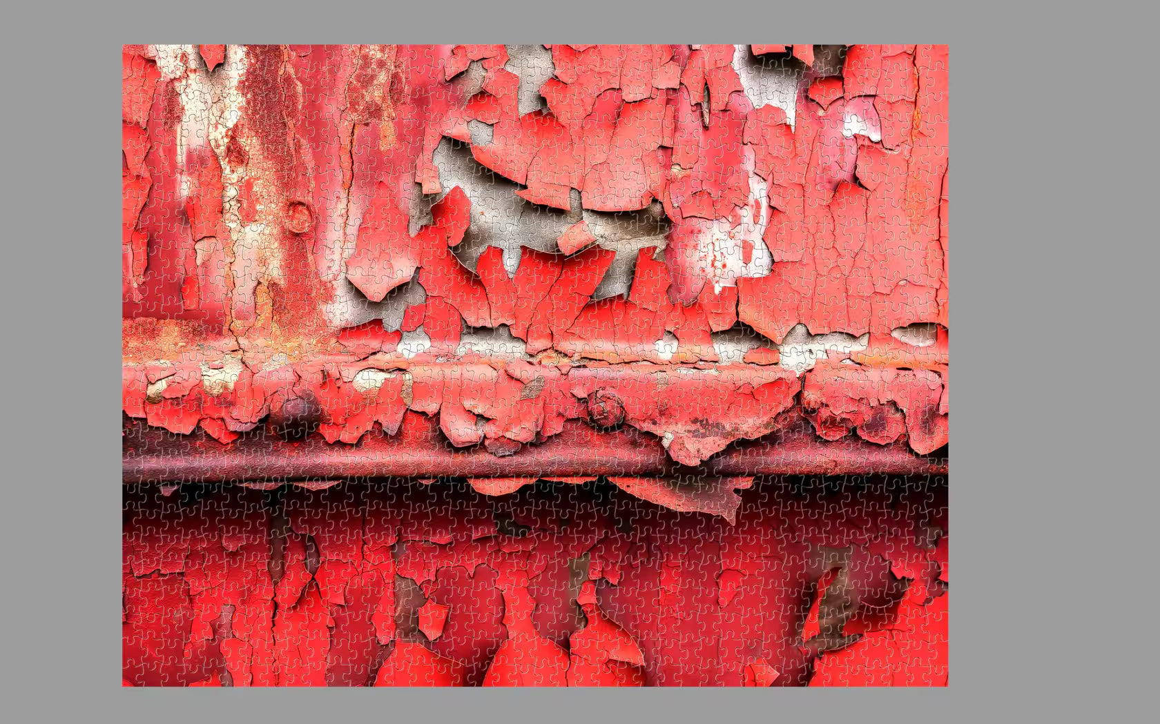 Close-up of peeling red paint on a metal surface