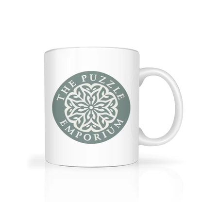 White mug with 'The Puzzle Emporium' logo on a white background