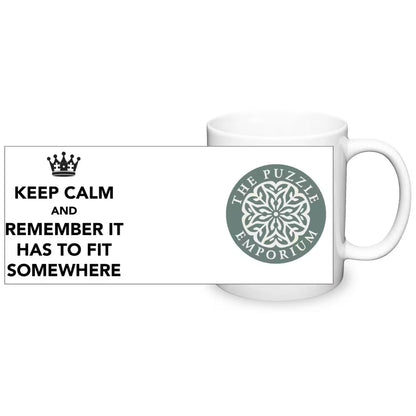 White mug with 'The Puzzle Emporium' logo and text 'Keep Calm and Remember It Has to Fit Somewhere'.