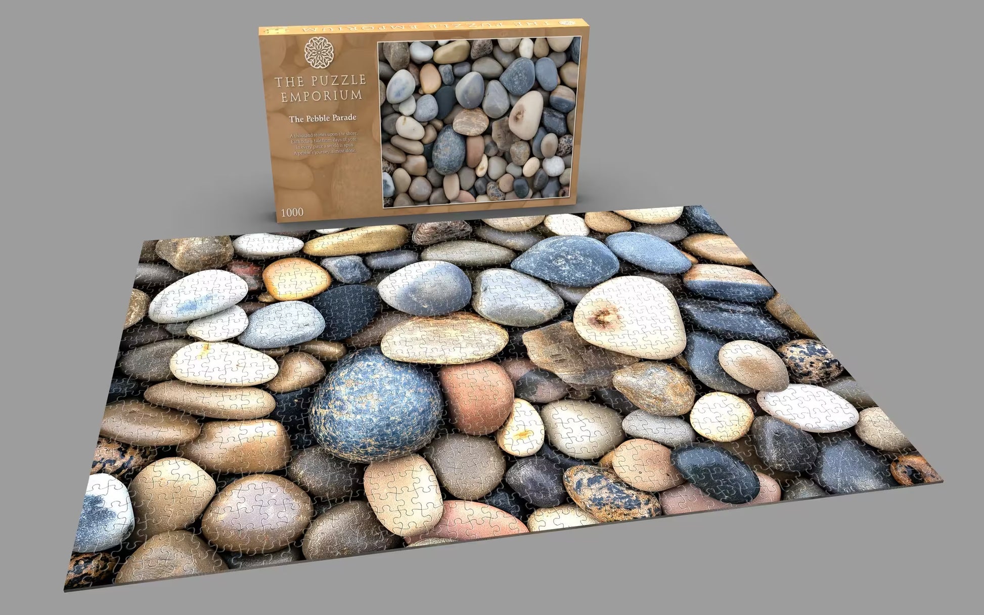 Pebble puzzle with packaging on a gray background